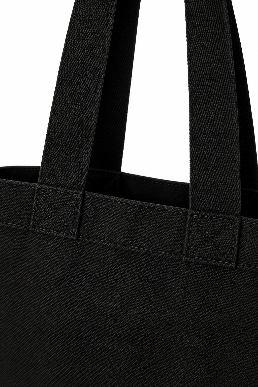 Close-up of the black Rev 22:12 canvas tote handles and strap attachments